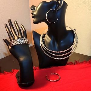 Silver braided necklace, bracelet, and 1 pair of earrings.